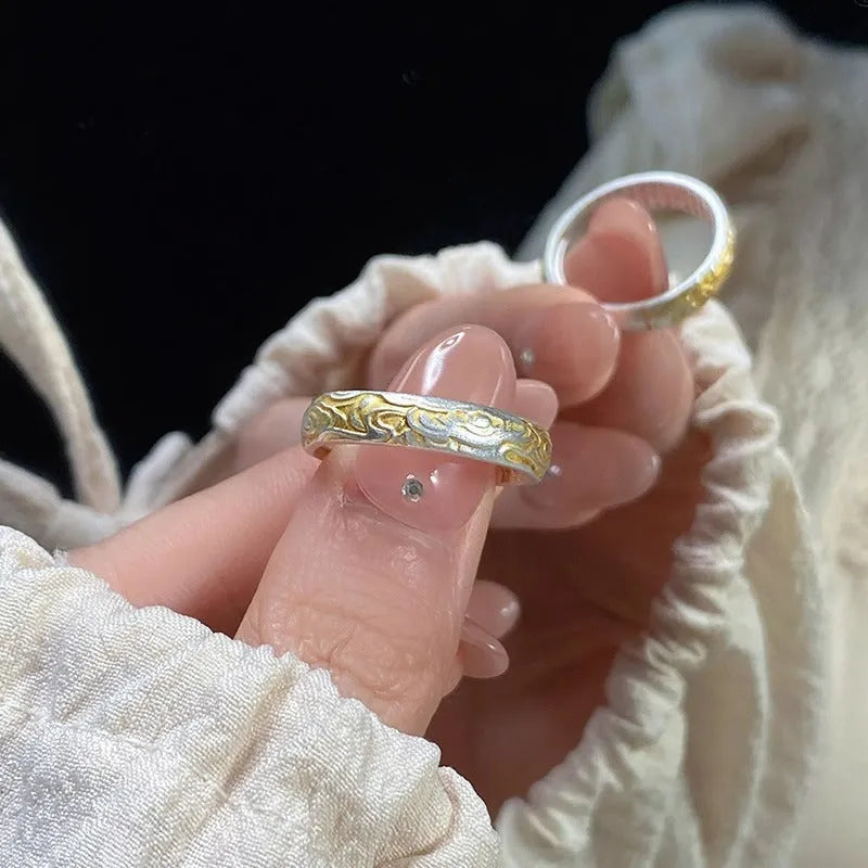 Open mouth silver and gold ring with a geometric Xiangyun pattern on a white copper band.