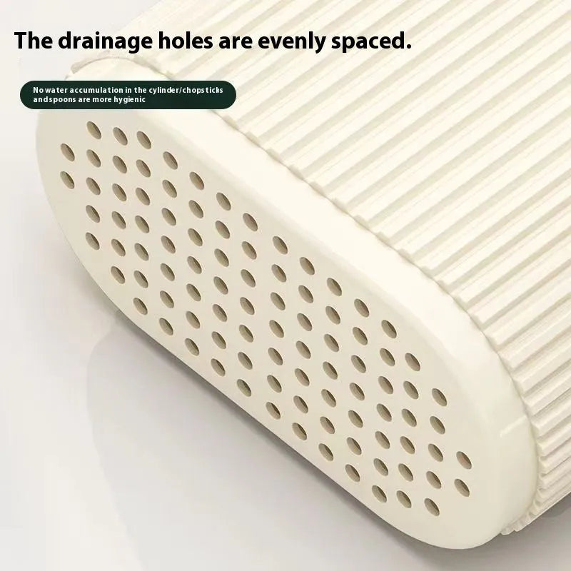 Plastic wall-mounted chopstick and spoon holder tube with drainage holes in beige colour.