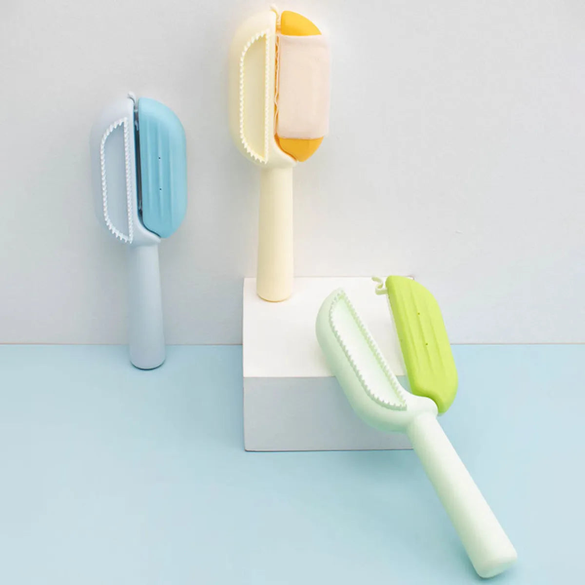 Blue pet grooming comb with water tank for removing hair and detangling knots on dogs and cats.