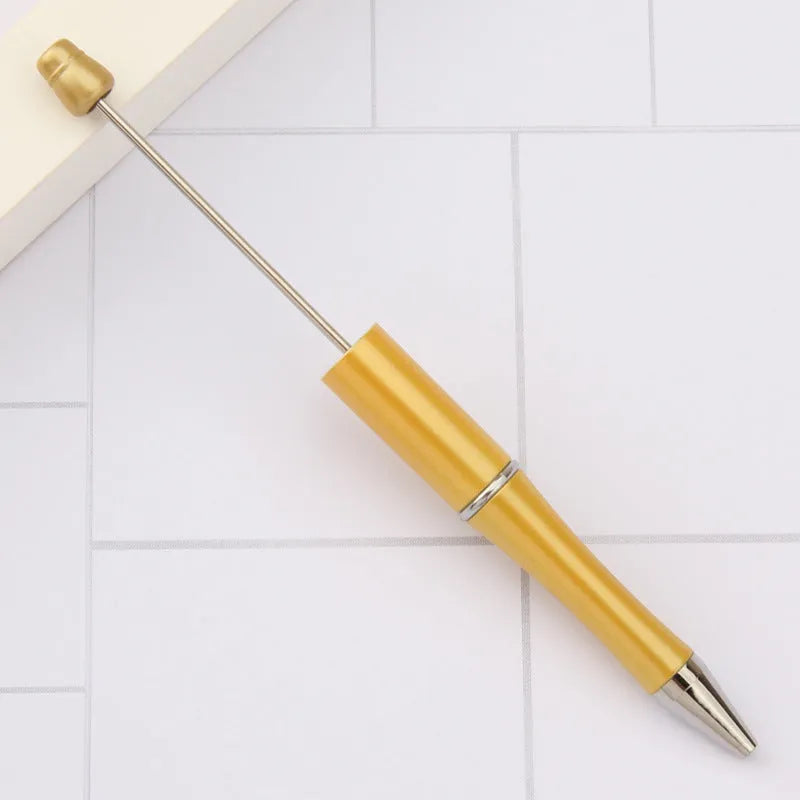 Creative ballpoint pen with multicoloured spinning plastic beads on a steel wire frame.