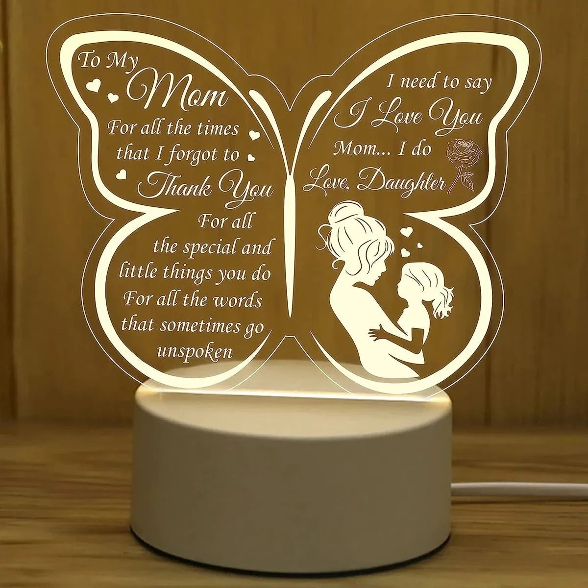 White heart-shaped table lamp with touch control and USB power cable on wooden surface