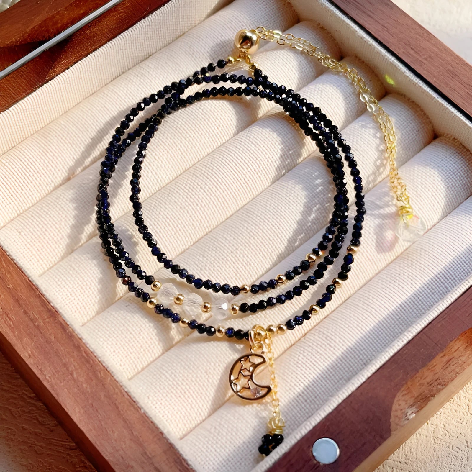 Handmade multi-layer women's bracelet in blue sand colour with three rings and stone-cut beads.