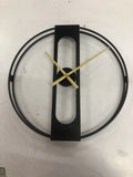 A large 50cm round metal wall clock on a wall, shown in black and gold colour variants.