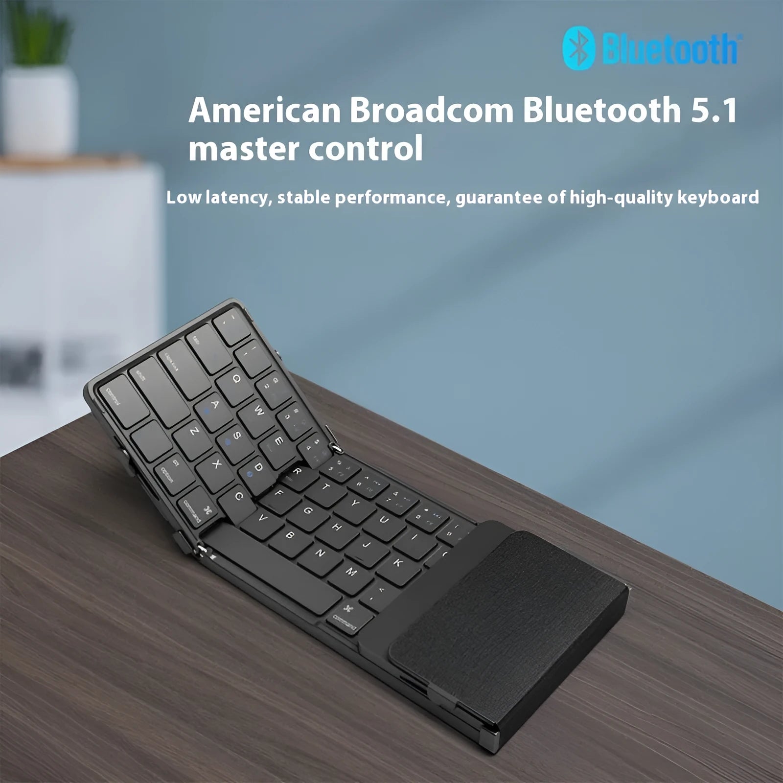 Black folding Bluetooth keyboard with touchpad unfolded showing full keyboard and touchpad surface