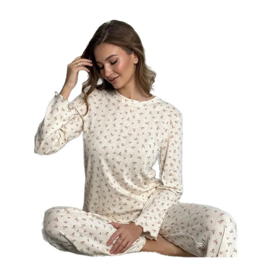 White floral print women's loungewear suit with bell sleeve top and wide-leg trousers.