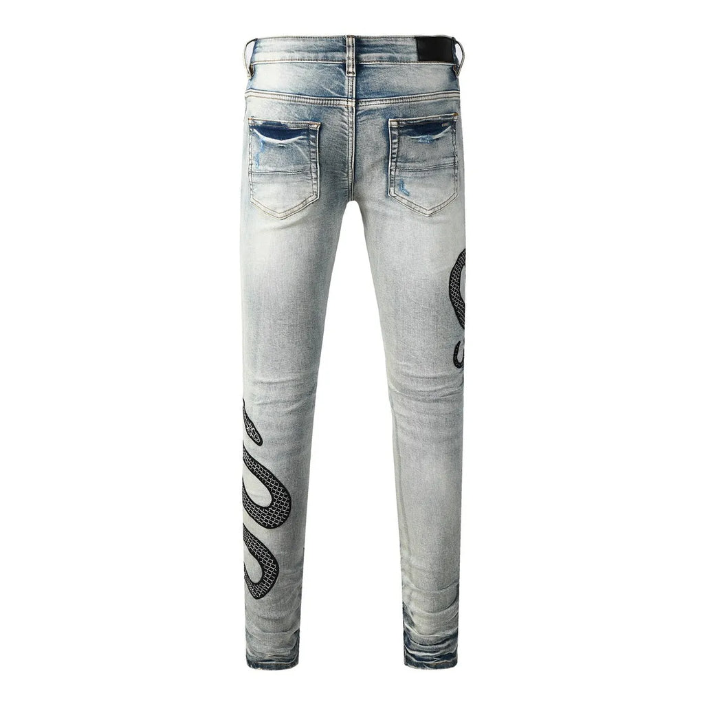 Blue distressed skinny jeans with a button fly on a mid waist, showing a slim fit and retro wash detail.
