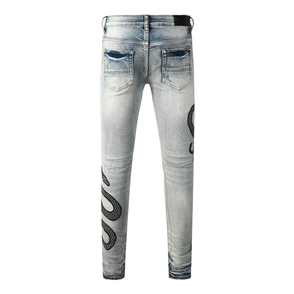 Blue distressed skinny jeans with a button fly on a mid waist, showing a slim fit and retro wash detail.