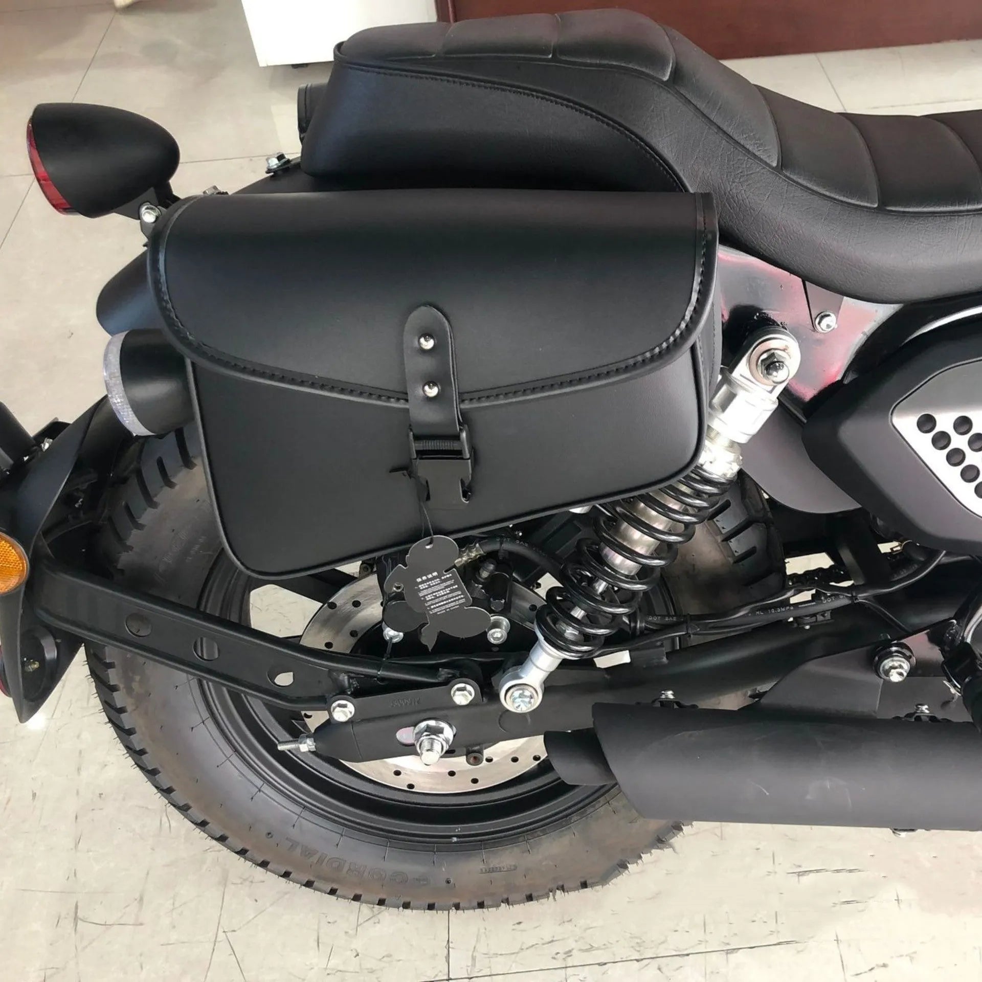 Black PU leather motorcycle swingarm saddlebag mounted on Sportster side showing 30x24x20cm dimensions