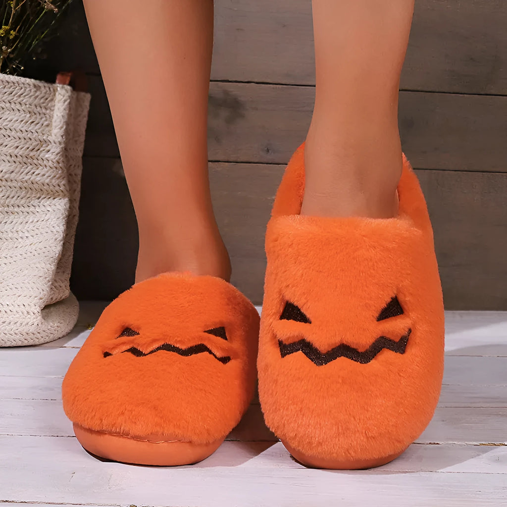 Orange Halloween pumpkin slippers with plush construction and non-slip soles in paired adult sizes