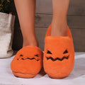 Orange Halloween pumpkin slippers with plush construction and non-slip soles in paired adult sizes