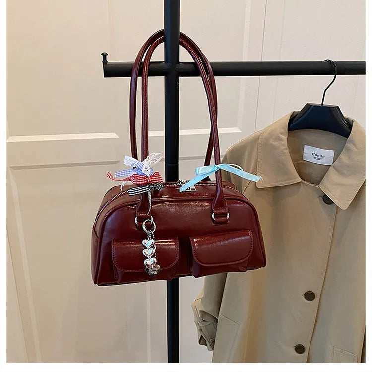 Retro brown PU leather women's shoulder bag with pillow-shaped design and double strap.