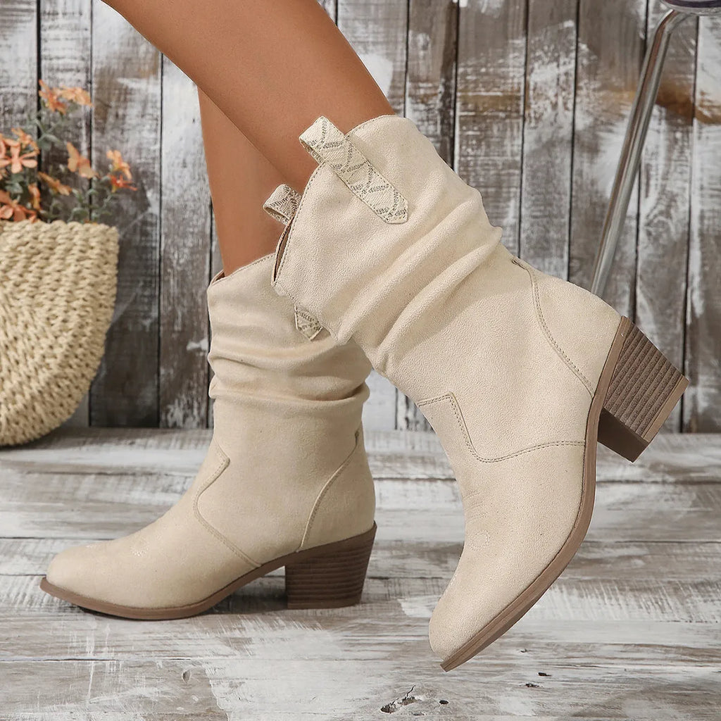 Women's mid-calf suede boots with chunky heel in lotus root colour on a plus size model.
