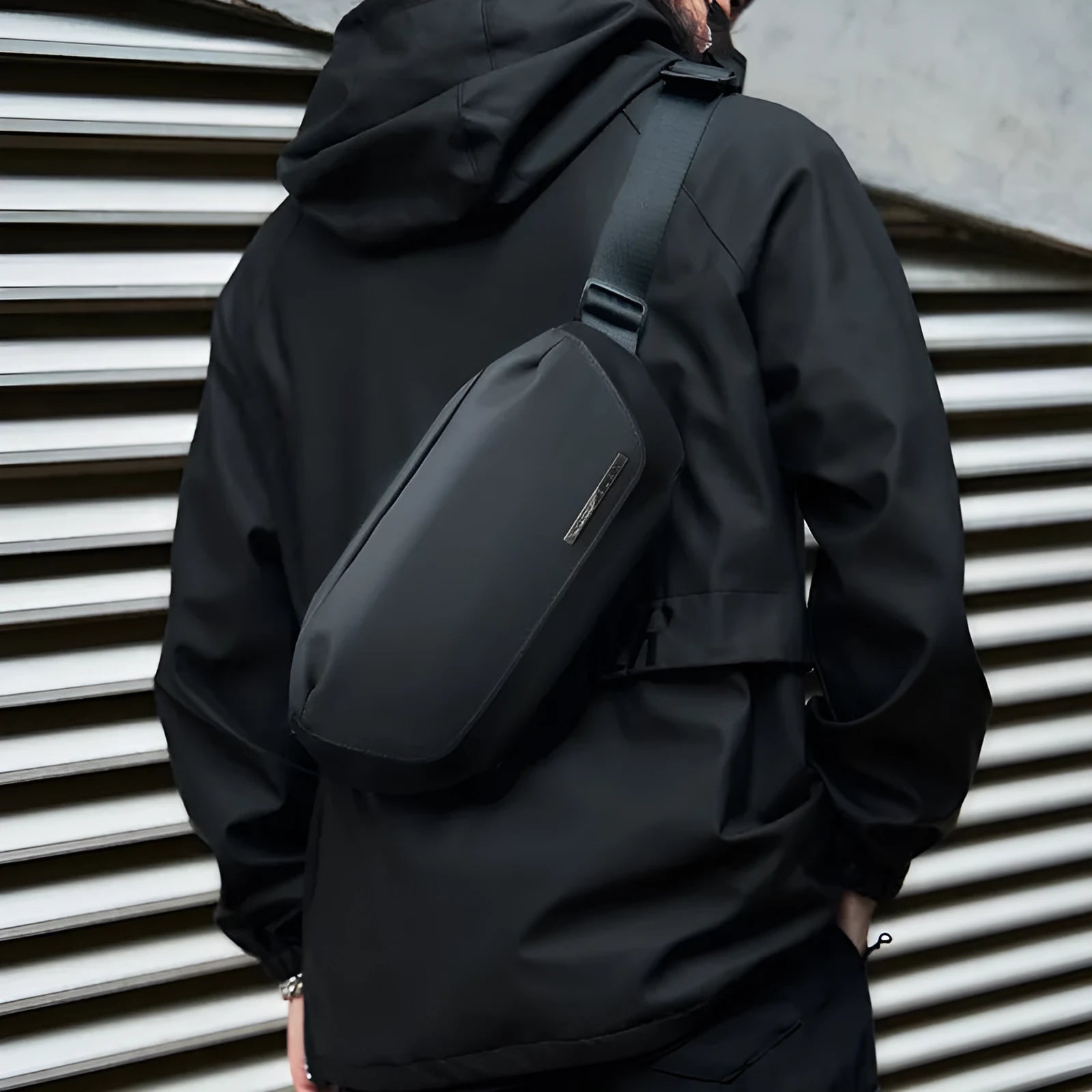 Black men's Oxford cloth messenger bag shown as a crossbody bag.