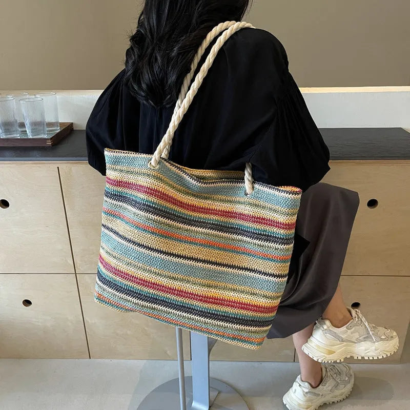 Blue straw woven large capacity nylon shoulder bag with a single strap.