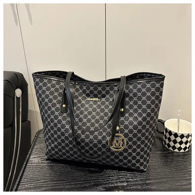 Structured black PU shoulder bag with sewing thread detail and a polyester lining.