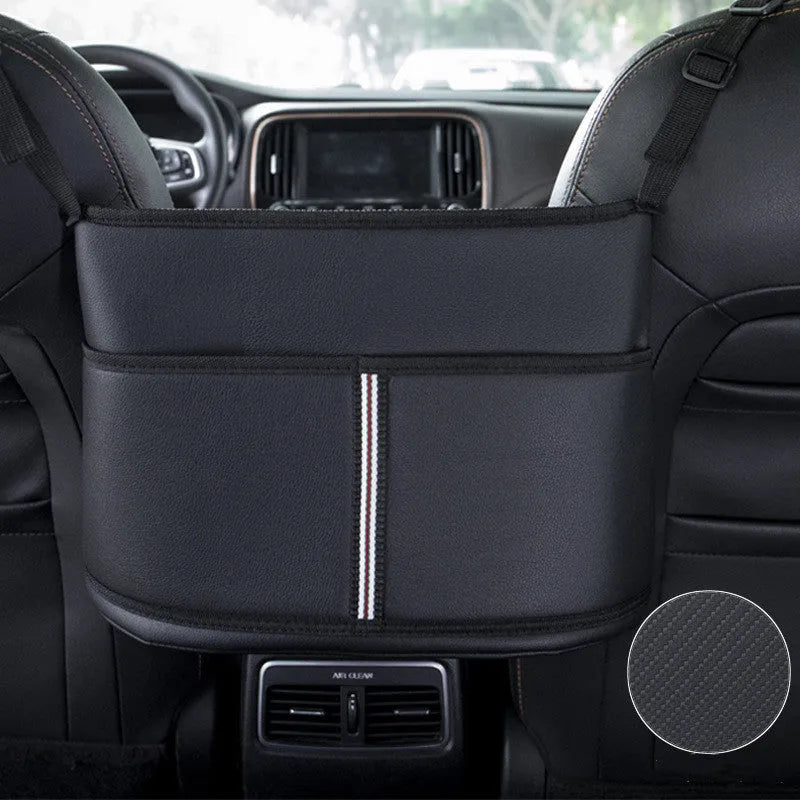 Black leather car seat storage bag with a carbon fibre pattern, shown between vehicle seats.