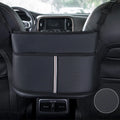 Black leather car seat storage bag with a carbon fibre pattern, shown between vehicle seats.