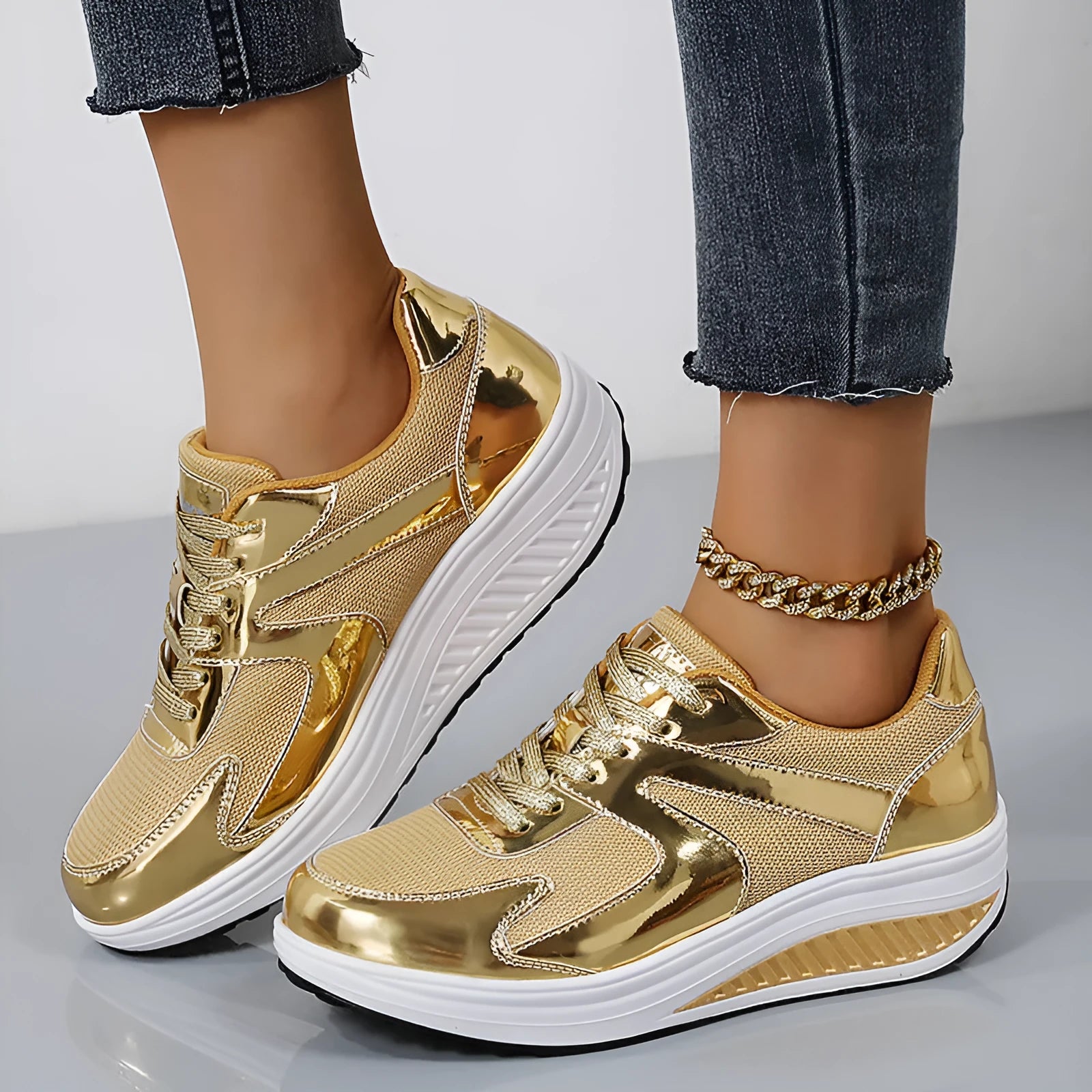 Women's gold platform shoes with mesh upper, round toe, and cross-strap detail