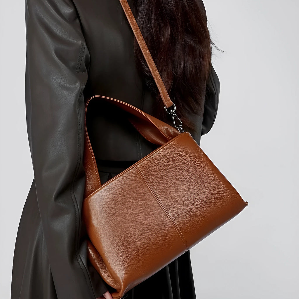 Women's genuine leather messenger bag in horizontal square shape with double shoulder strap, shown in apricot colour.