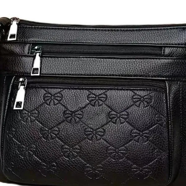 Butterfly black PU leather women's crossbody messenger bag showing embossed pattern and horizontal square shape