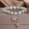 White cat's eye stone women's bracelet with flower tassels and safety buckle