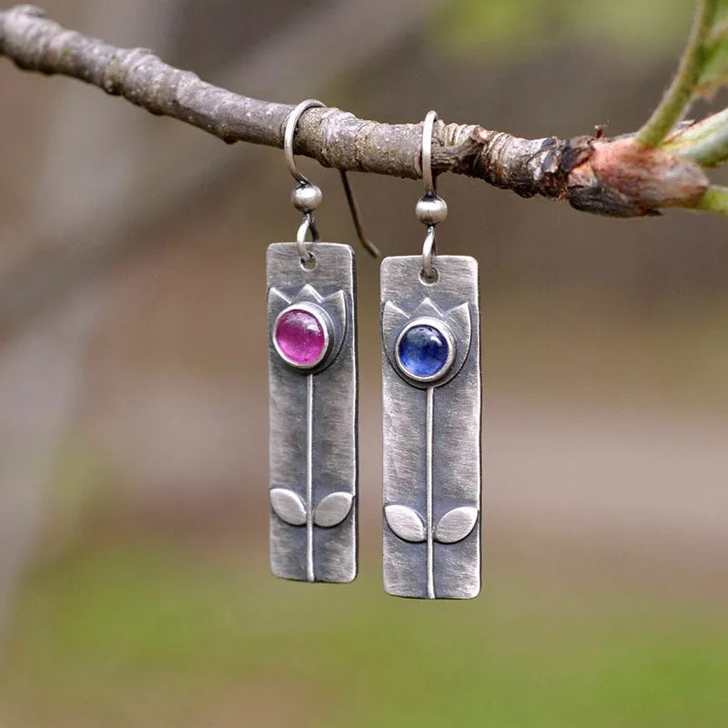 Red sapphire earrings with antique metal finish and geometric ellipse design