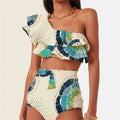 White women's one-shoulder swimsuit with a cascading lotus leaf ruffle and high-leg split.