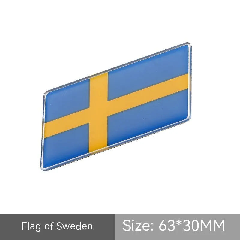 Aluminium parallelogram car sticker with national flag design measuring 6.3 by 3 cm