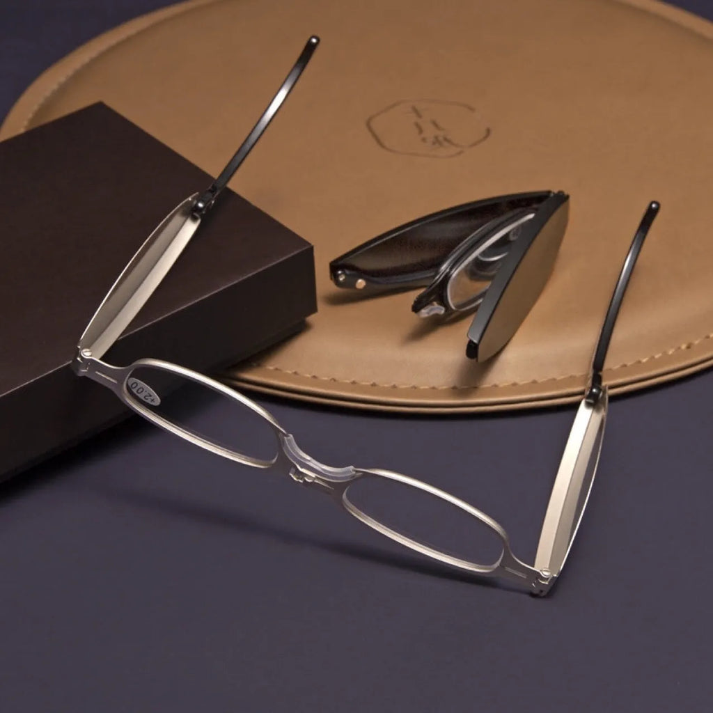 Black folding presbyopic reading glasses with round retro lenses, shown in open and closed positions.