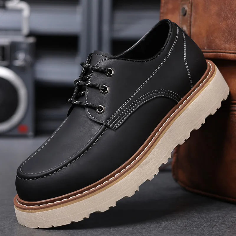 Men's black retro Martin boots with round toe and low-top design on a plain background
