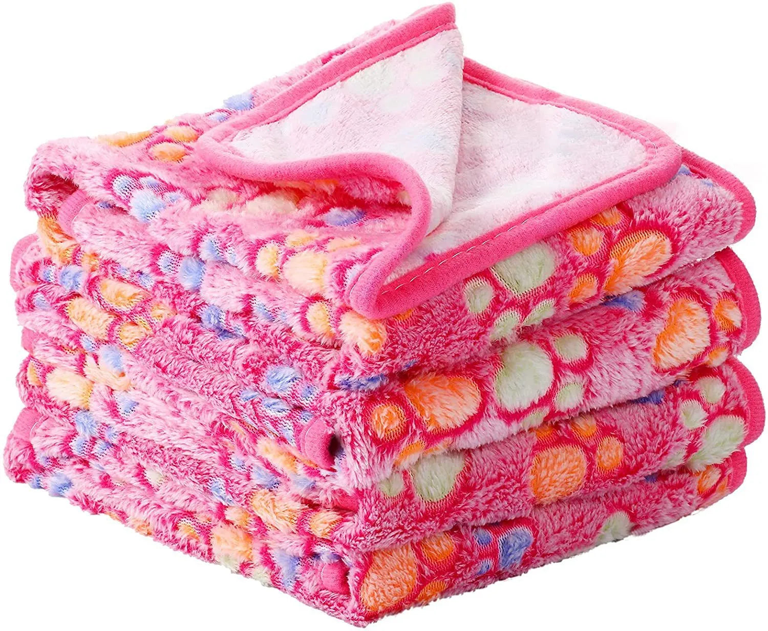Coral fleece dog blanket with paw print pattern in beige, shown in a large size on a dog bed.