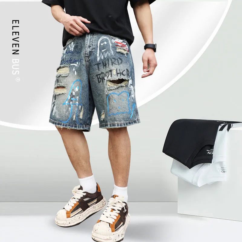 Blue ripped men's denim shorts with graffiti print and a zipper fly
