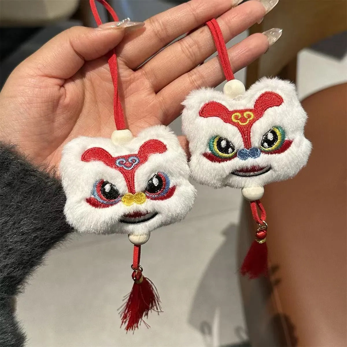 Blue and yellow cartoon plush lion keychain ornament with tassel and star stone.