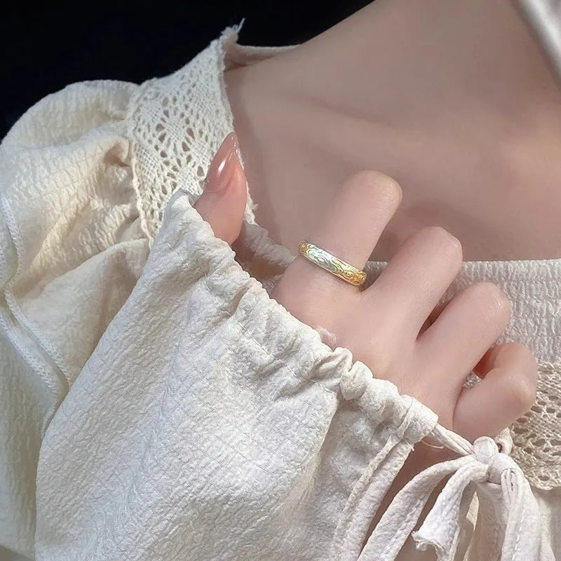 Open mouth silver and gold ring with a geometric Xiangyun pattern on a white copper band.