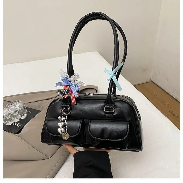 Retro brown PU leather women's shoulder bag with pillow-shaped design and double strap.
