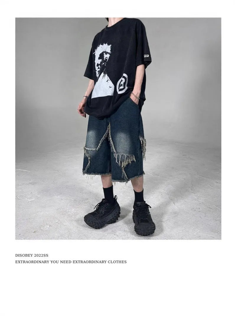 Men's blue distressed denim shorts with a large five-pointed star and frayed hem in a loose cargo fit.