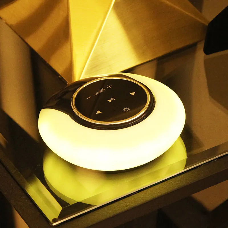 DEAMAK-1 Bluetooth speaker with integrated LED desk lamp showing folding design and touch controls