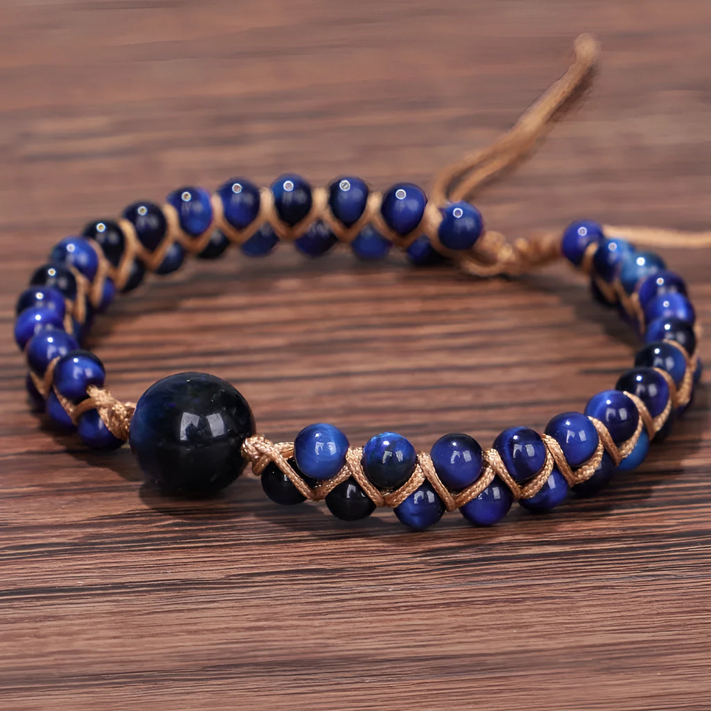 Handmade woven bracelet with geometric pattern in blue tigereye stone beads and pull closure.