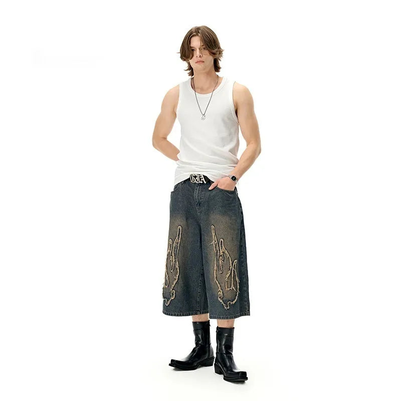 Men's black denim shorts with flame embroidery patch detailing, cropped length, straight leg cut