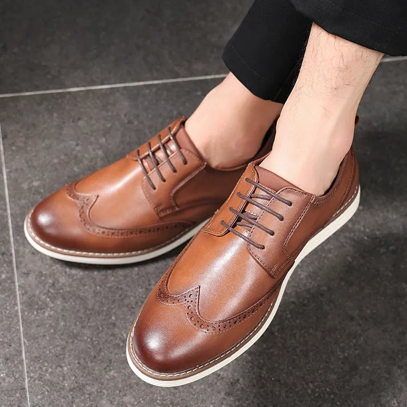 Men's black and brown slip-on business casual shoes with round toe and decorative carving detail