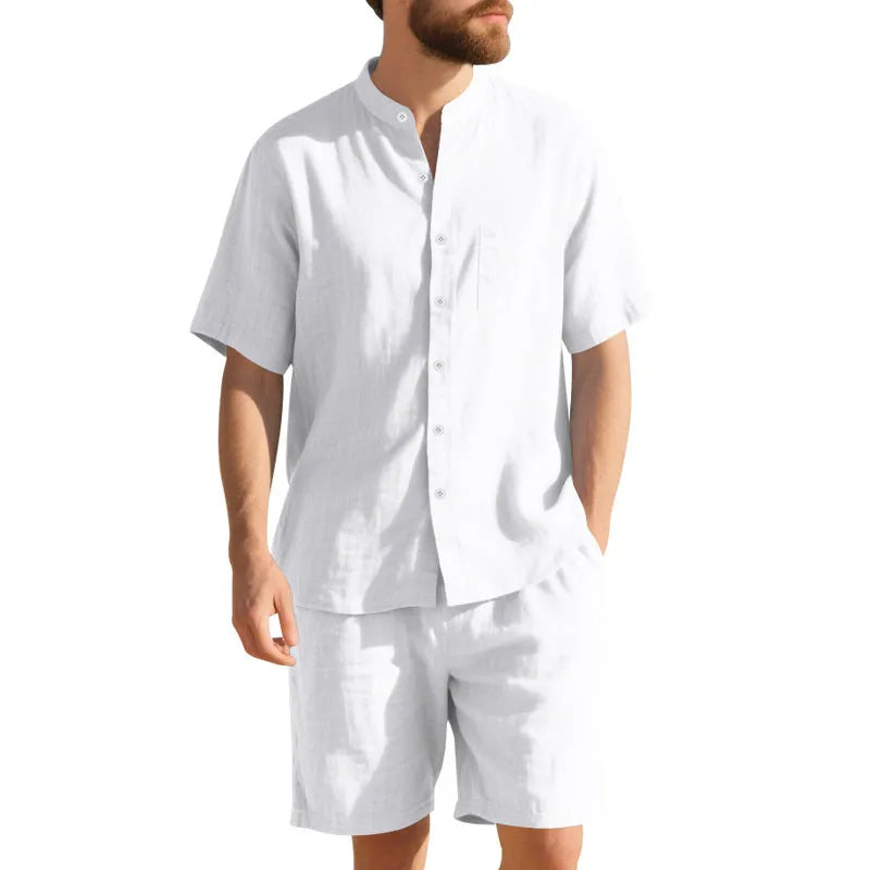 Man wearing a light blue linen blend short sleeve shirt and matching shorts, a casual summer two-piece suit.