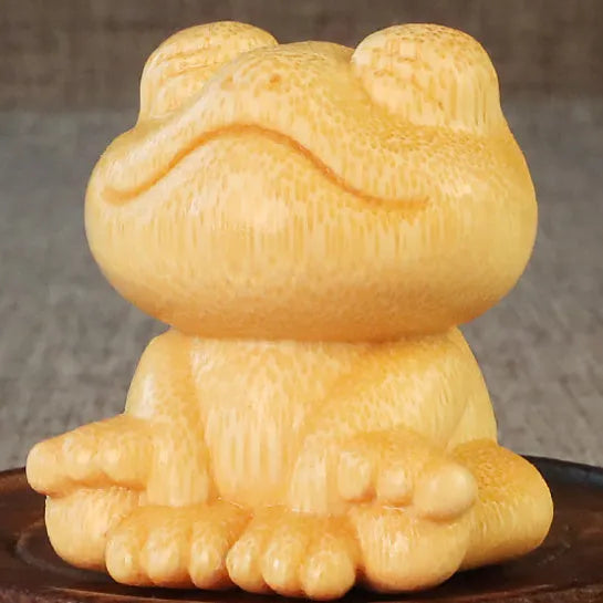 Small smiling frog ornament carved from solid bamboo measuring 5cm in height