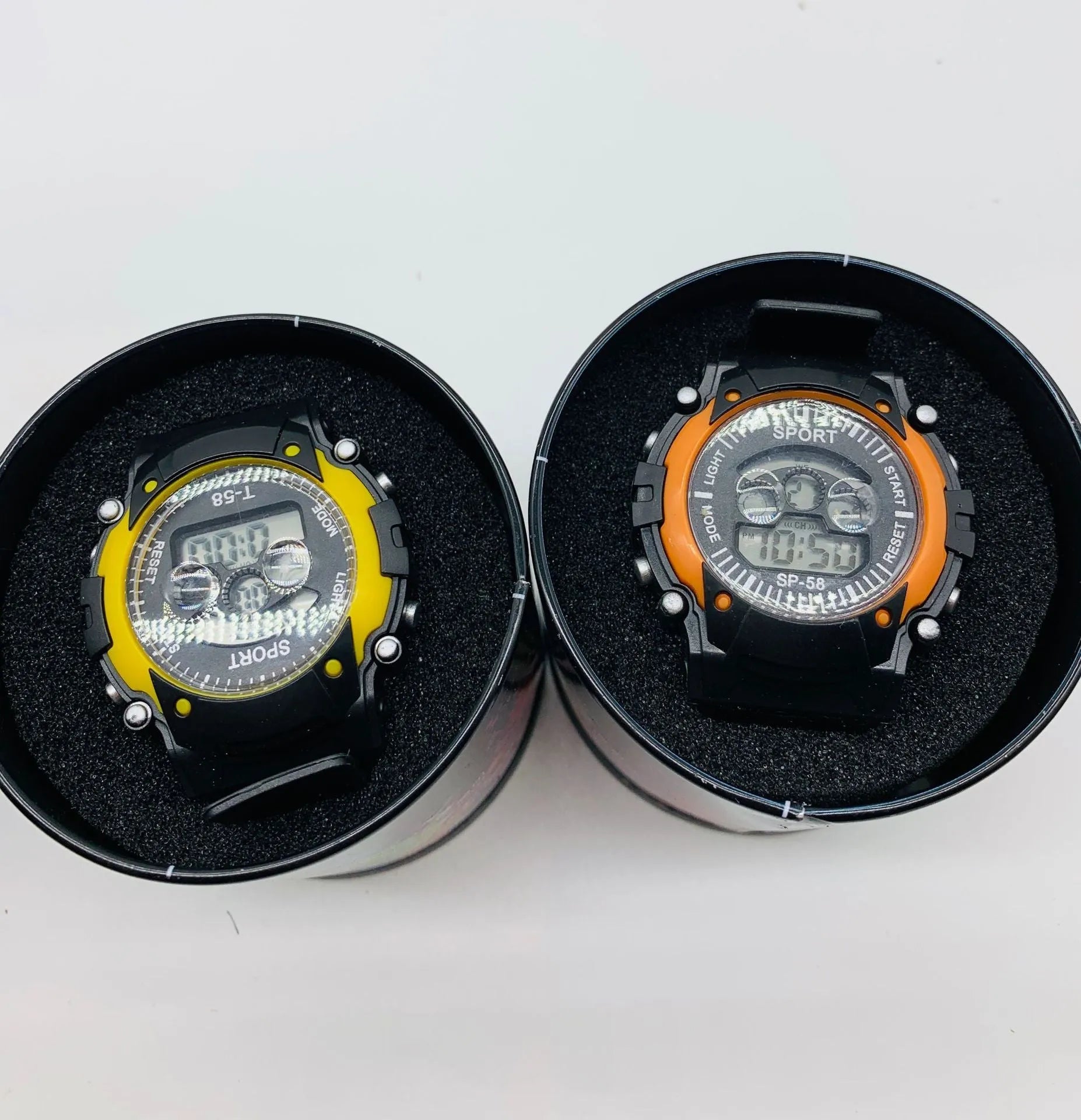 Children's digital sports watch with large black display showing time, red silicone strap, and plastic case