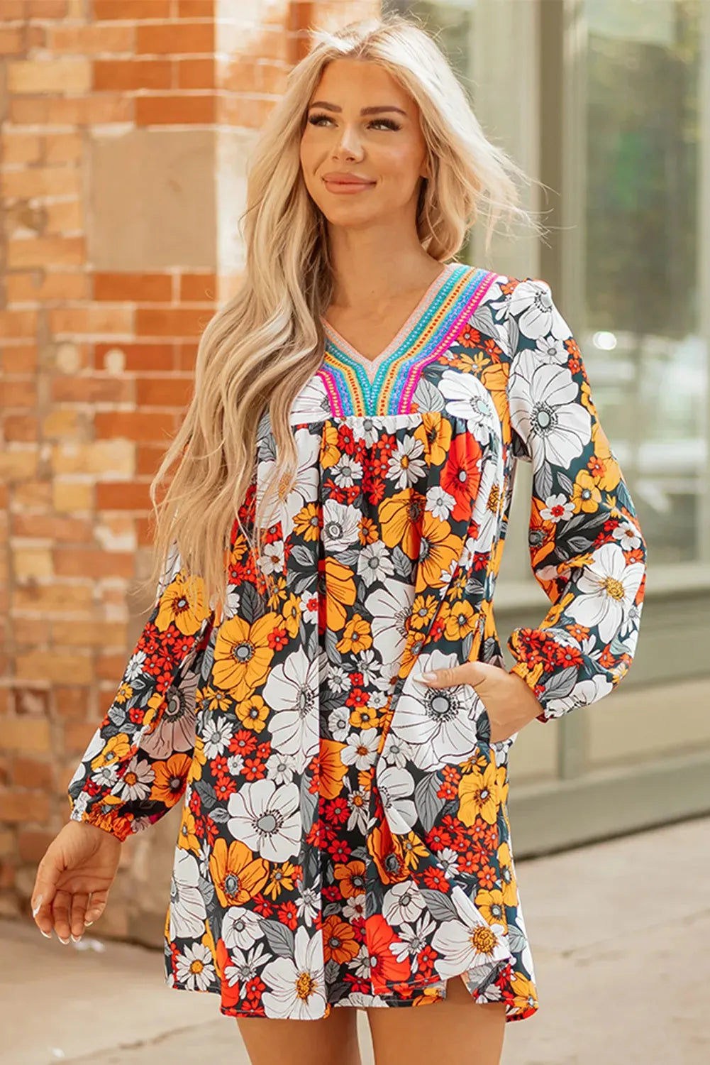 Orange women's mini dress with floral striped print and lace detailing, featuring a V neck and long sleeves.