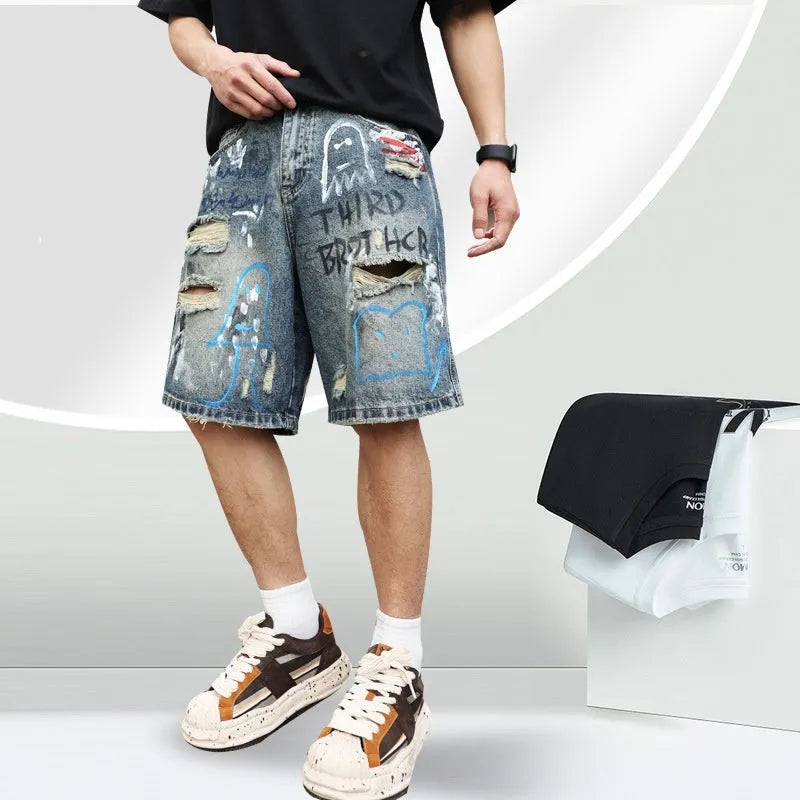 Blue ripped men's denim shorts with graffiti print and a zipper fly