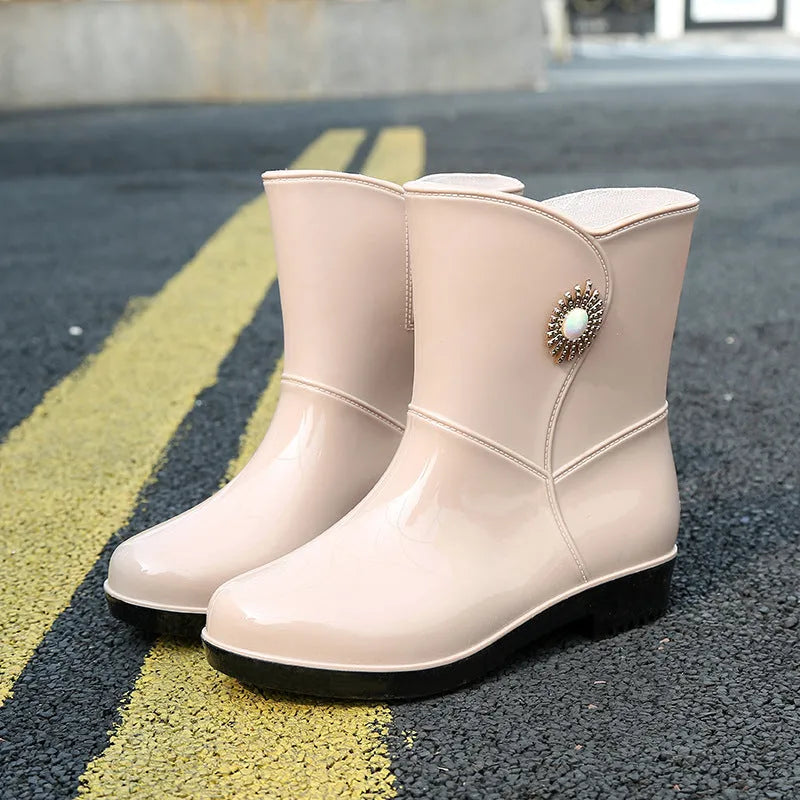 Women's purple rain boot with middle tube height and textured non-slip sole.