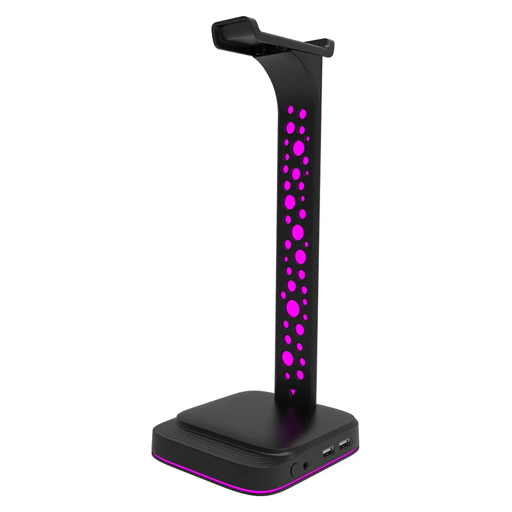 RGB colour changing headphone display stand with dual USB ports on a desk