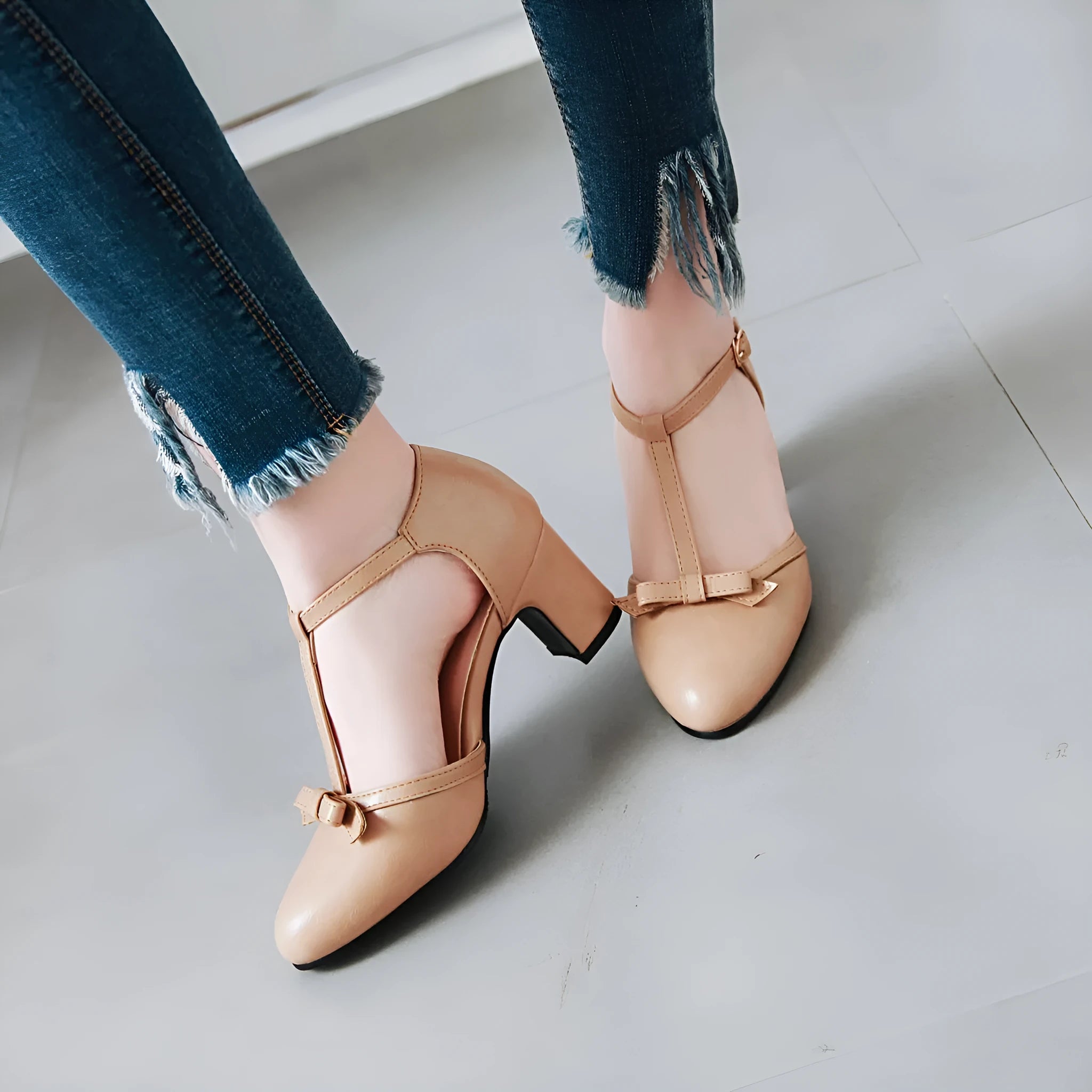 Yellow women's sandals with a buckle strap, chunky 6.5 cm heel, hollow-out pattern, and a bow tie.