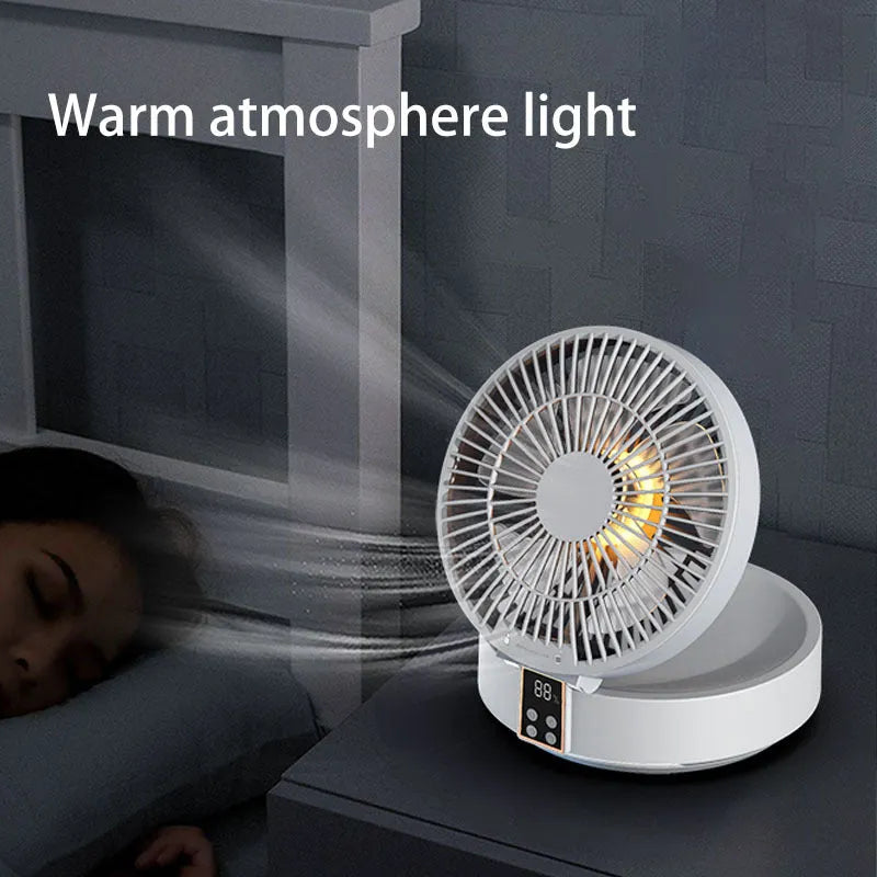 White portable folding desk fan with remote control and warm night light on a table