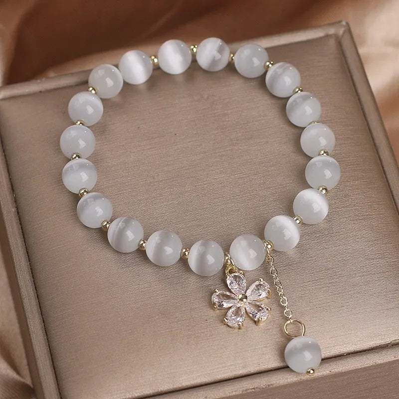 White cat's eye stone women's bracelet with flower tassels and safety buckle